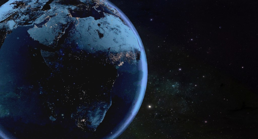 Mirror image from space of Africa and Saudi Arabia on the left and the starlit night sky on the right.